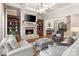 Beautiful living room featuring fireplace, hardwood floors, and coffered ceilings at 9011 Pine Laurel Dr, Weddington, NC 28104