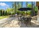 Outdoor patio boasts built-in grill, comfortable seating area and shade umbrella, perfect for relaxing outdoors at 9011 Pine Laurel Dr, Weddington, NC 28104