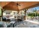 Outdoor patio boasts a covered pavilion with stone columns, built-in grill, and comfortable seating area at 9011 Pine Laurel Dr, Weddington, NC 28104