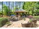 Inviting outdoor space featuring an outdoor fireplace, dining and lounge area at 9011 Pine Laurel Dr, Weddington, NC 28104