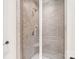 Modern shower with bench, tile surround, glass door, and chrome fixtures at 9011 Pine Laurel Dr, Weddington, NC 28104