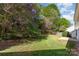 The backyard has a small patio, healthy grass, and shade from mature trees at 10429 Madison Park Dr, Charlotte, NC 28269