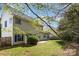 View of the home's backyard featuring green grass, a patio, and framed by trees at 10429 Madison Park Dr, Charlotte, NC 28269