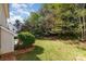 The backyard has healthy green grass, mature trees, and partial shade at 10429 Madison Park Dr, Charlotte, NC 28269