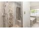 Custom walk-in shower with stone accents and a deep soaking tub at 10429 Madison Park Dr, Charlotte, NC 28269