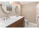 Bathroom with double sink vanity, modern fixtures, and decorative mirrors at 10429 Madison Park Dr, Charlotte, NC 28269