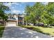 Spacious home featuring a long driveway, two-car garage, and lush green lawn at 10429 Madison Park Dr, Charlotte, NC 28269