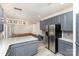 Modern kitchen featuring stainless steel appliances, granite countertops, and gray cabinets at 10429 Madison Park Dr, Charlotte, NC 28269