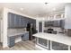 Modern kitchen with gray cabinets, an island with granite countertop, and stainless steel appliances at 10429 Madison Park Dr, Charlotte, NC 28269