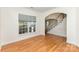 Bright room with hardwood floors, a large window, and staircase in view at 10429 Madison Park Dr, Charlotte, NC 28269