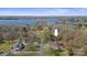 Aerial view showcasing a home near a lake, surrounded by lush greenery and mature trees at 118 Lakewood Dr, Kings Mountain, NC 28086