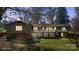 Rear of home with a white-railed deck and lower-level storage, nestled in a green backyard at 118 Lakewood Dr, Kings Mountain, NC 28086