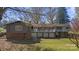 Rear of home with a white-railed deck and lower-level storage, nestled in a green backyard at 118 Lakewood Dr, Kings Mountain, NC 28086