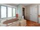 Bathroom featuring a pink corner tub, stall shower, and plenty of light at 118 Lakewood Dr, Kings Mountain, NC 28086