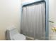 Bathroom with toilet and a bathtub with shower curtain and silver hardware at 118 Lakewood Dr, Kings Mountain, NC 28086