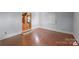Neutral bedroom with hardwood flooring, base molding, and doorway to another room at 118 Lakewood Dr, Kings Mountain, NC 28086