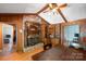 Dining room showcasing a brick fireplace, wood paneled walls, and access to multiple rooms at 118 Lakewood Dr, Kings Mountain, NC 28086