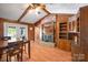 Open dining room with a brick fireplace, wood paneled walls, built-in storage, and french doors to yard at 118 Lakewood Dr, Kings Mountain, NC 28086