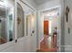 Hallway with mirrored closet doors leading to the entryway with a decoratve table and marble floors at 118 Lakewood Dr, Kings Mountain, NC 28086