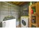 Basement laundry area with washer, dryer, concrete block walls, and wood floors at 118 Lakewood Dr, Kings Mountain, NC 28086