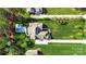 Aerial view of the property showcases a beautiful pool, manicured lawns, and a private driveway at 125 Trent Pines Dr, Mooresville, NC 28117