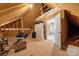 Spacious unfinished attic with exposed rafters and plywood flooring adjacent to a bedroom at 125 Trent Pines Dr, Mooresville, NC 28117