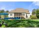 Backyard featuring a screened-in porch, in-ground pool with a cover, and a spacious manicured lawn at 125 Trent Pines Dr, Mooresville, NC 28117