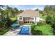 Backyard featuring a screened-in porch, in-ground pool with a cover, and a spacious manicured lawn at 125 Trent Pines Dr, Mooresville, NC 28117