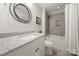 Modern bathroom features a granite countertop, updated fixtures, and a tiled shower-tub at 125 Trent Pines Dr, Mooresville, NC 28117