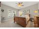 Bedroom featuring carpeted floors, a ceiling fan, two windows, and neutral colored walls at 125 Trent Pines Dr, Mooresville, NC 28117
