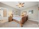 Cozy bedroom with carpet, a ceiling fan, and a wooden sleigh bed, offering a relaxing retreat at 125 Trent Pines Dr, Mooresville, NC 28117