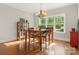Dining room with hardwood floors, a traditional table and chairs, chandelier, and natural light from the large windows at 125 Trent Pines Dr, Mooresville, NC 28117