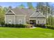 Beautiful one story home boasts professionally landscaped yard with manicured lawn and hedges at 125 Trent Pines Dr, Mooresville, NC 28117