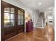 Welcoming foyer featuring hardwood floors, staircase, and view into other rooms at 125 Trent Pines Dr, Mooresville, NC 28117