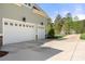 Spacious two-car garage with white doors and a long driveway, providing ample parking and curb appeal at 125 Trent Pines Dr, Mooresville, NC 28117