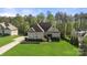Beautifully landscaped home featuring lush green lawns, mature trees, and a welcoming front entrance at 125 Trent Pines Dr, Mooresville, NC 28117