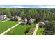 Beautifully landscaped home featuring lush green lawns, mature trees, and a long private driveway at 125 Trent Pines Dr, Mooresville, NC 28117