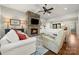 Cozy living room featuring a stone fireplace, coffered ceilings, and stylish seating at 125 Trent Pines Dr, Mooresville, NC 28117
