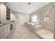 Large main bathroom featuring tiled floor, a vanity, mirror, glass enclosed shower, and a separate soaking tub at 125 Trent Pines Dr, Mooresville, NC 28117
