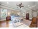 Spacious main bedroom featuring hardwood floors, a ceiling fan, and a trey ceiling with natural light at 125 Trent Pines Dr, Mooresville, NC 28117