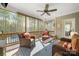 Relaxing screened porch with wicker furniture and a view of the wooded backyard and pool at 125 Trent Pines Dr, Mooresville, NC 28117