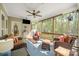Inviting screened porch with comfortable seating, a ceiling fan, and a view of the natural surroundings at 125 Trent Pines Dr, Mooresville, NC 28117