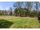 Large, grassy backyard with mature trees offering shade and privacy at 1268 Scotch Meadows Loop, Monroe, NC 28110