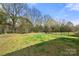 Expansive backyard featuring a grassy lawn with a partial view of a black metal fence at 1268 Scotch Meadows Loop, Monroe, NC 28110