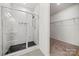 Bathroom showcasing a glass enclosed shower with marble style tile and a view into the walk-in closet at 1268 Scotch Meadows Loop, Monroe, NC 28110