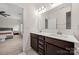 Modern bathroom featuring a double vanity with white countertops and dark brown cabinets adjacent to the bedroom at 1268 Scotch Meadows Loop, Monroe, NC 28110