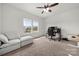 Carpeted bedroom with a cozy couch, a work space and natural light from two windows at 1268 Scotch Meadows Loop, Monroe, NC 28110