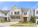 Inviting two-story home boasting a brick-accented two-car garage and well-manicured front lawn at 1268 Scotch Meadows Loop, Monroe, NC 28110
