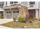 Close-up view of the garage and front garden, showcasing brick and vibrant landscaping at 1268 Scotch Meadows Loop, Monroe, NC 28110