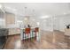 Bright, open kitchen with modern fixtures, an island with seating, and ample storage space at 1268 Scotch Meadows Loop, Monroe, NC 28110